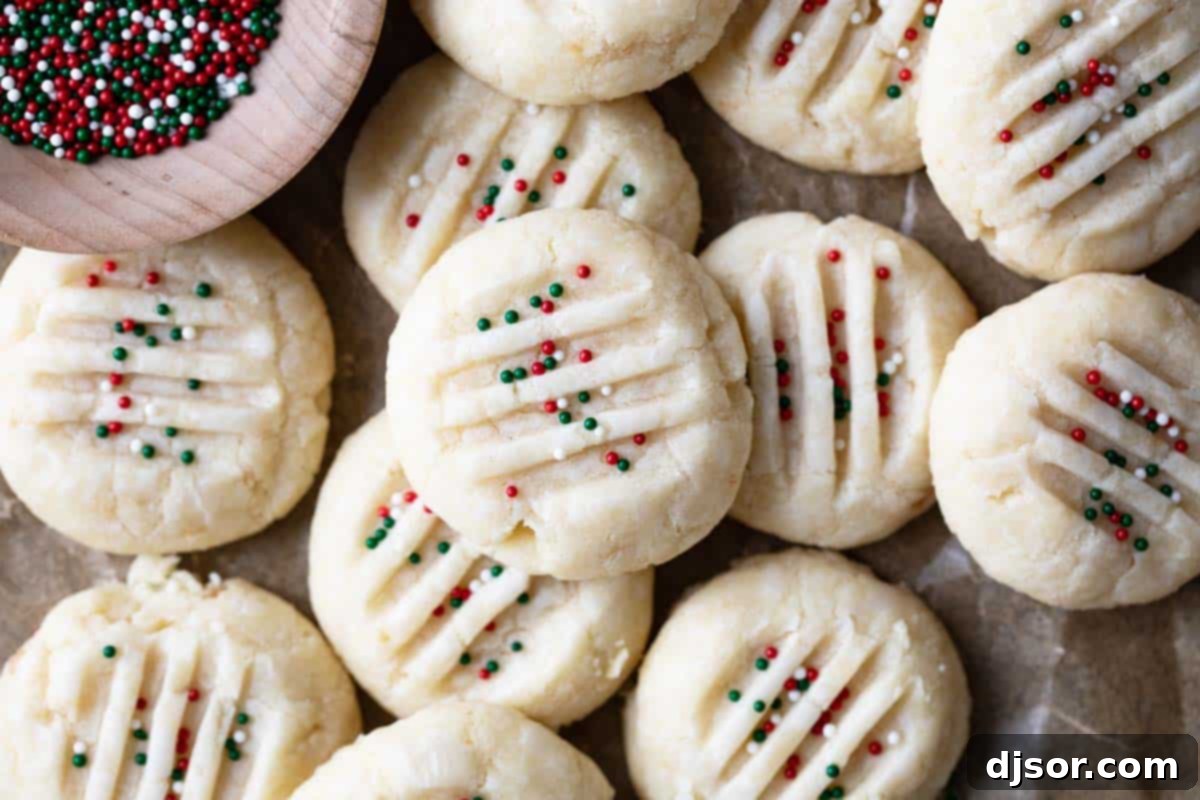 Christmas Shortbread Cookies topped with red, green, and white sprinkles, ready to be enjoyed.