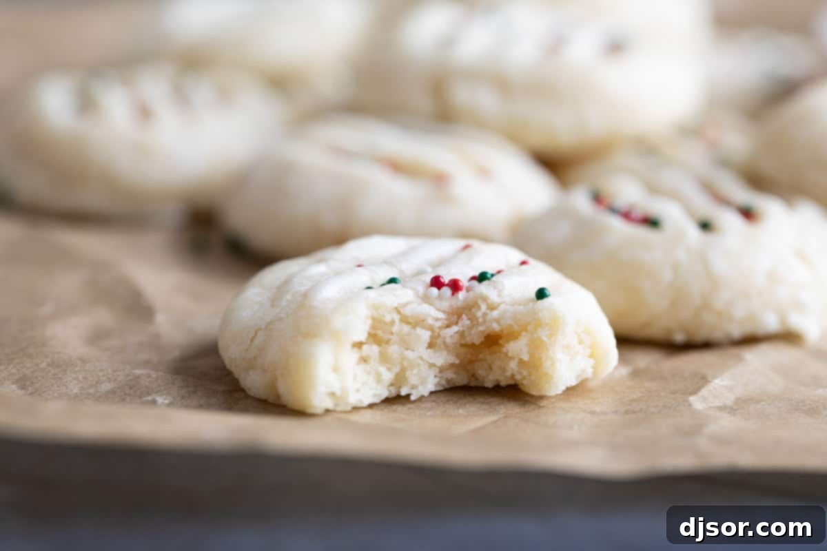 A Christmas Shortbread Cookie with a bite taken out, showcasing its tender texture.