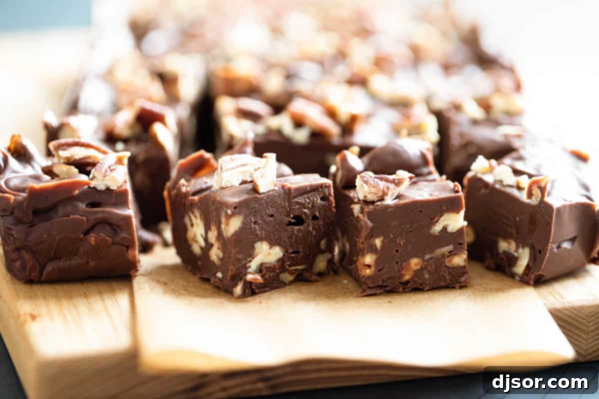 Slices of easy fudge with pecans, showcasing a smooth and creamy texture.
