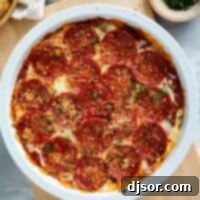 Pepperoni Pizza Dip topped with red pepper flakes and parsley.