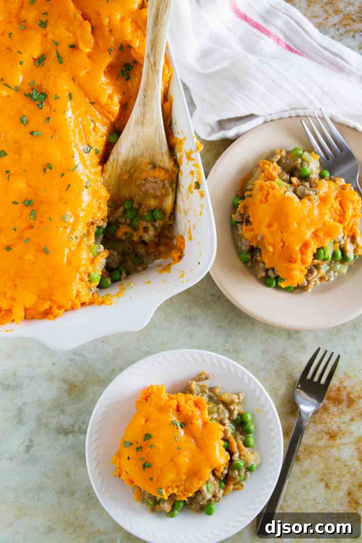 Golden Sweet Potato Topped Turkey Shepherds Pie 4 Two plates, each with a generous and neatly presented serving of Turkey Shepherd's Pie, showcasing the vibrant colors and appealing layers of the dish ready for a family meal.