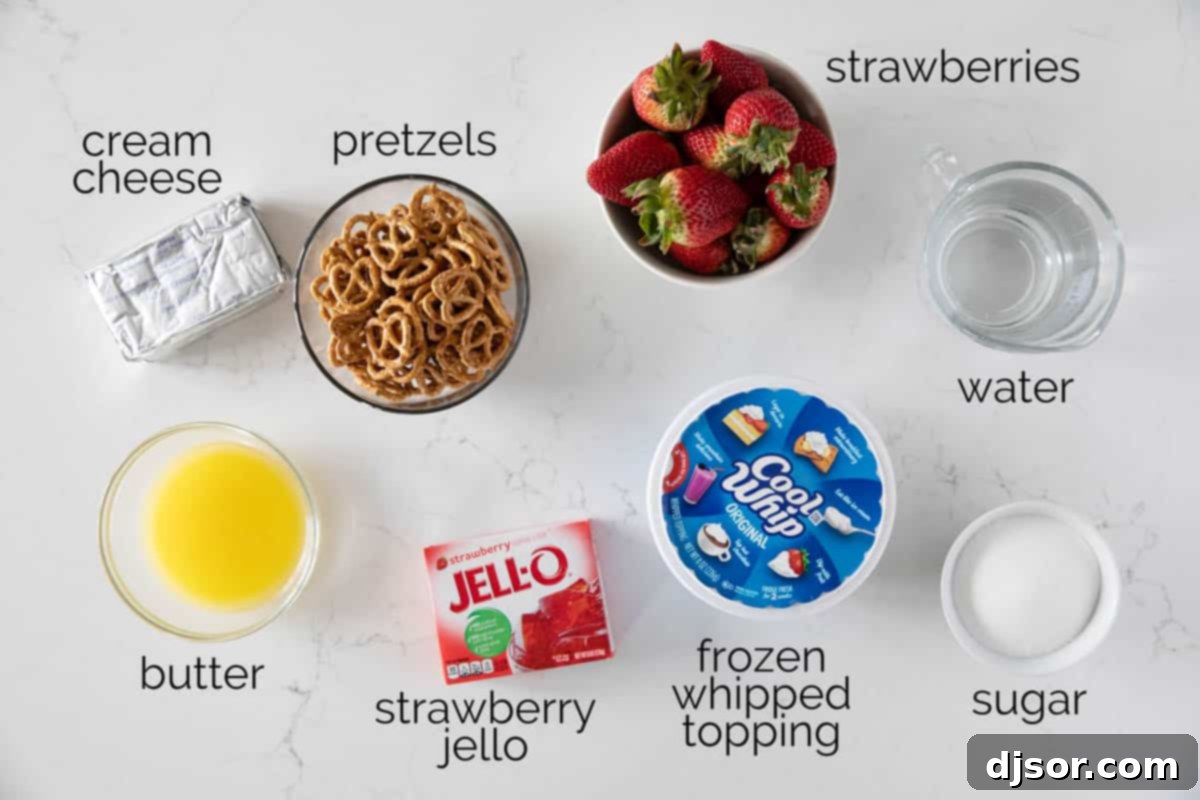 Sweet and salty, this Strawberry Pretzel Salad is as pretty as it is delicious. Serve it as a side dish or a dessert - either way, it’s always a hit! Ingredients laid out on a table for making Strawberry Pretzel Salad.