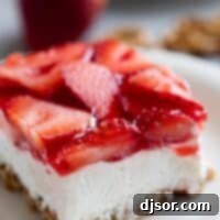 Strawberry Pretzel Perfection 2 Slice of strawberry pretzel salad topped with fresh strawberries.