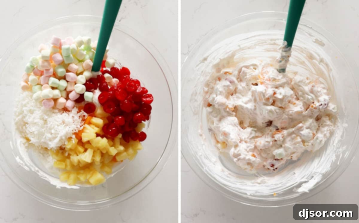 Stirring All Ingredients for Ambrosia Salad A large green mixing bowl filled with the ingredients for Ambrosia Salad, including a creamy white base, orange mandarin segments, yellow pineapple tidbits, red cherries, white marshmallows, and shredded coconut, being gently stirred together.