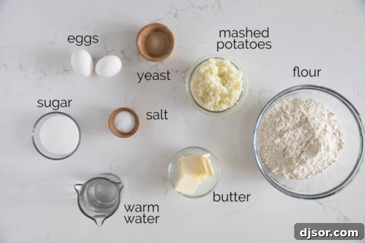 Arrangement of ingredients including flour, potatoes, butter, eggs, sugar, yeast, and salt, ready for making potato rolls.