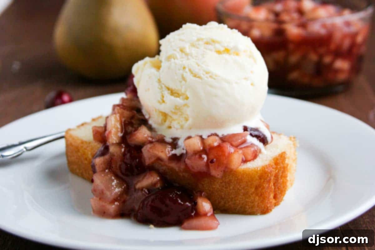Cranberry Sauce over Pound Cake with ice cream on a plate - a perfect Thanksgiving leftover dessert.