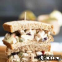 Honey Mustard Turkey Salad Sandwich 2 Two half turkey salad sandwiches stacked on top of each other, highlighting the texture and freshness of the filling.