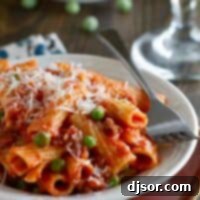 Rigatoni with Sausage, Peas, Tomatoes and Cream in a dish