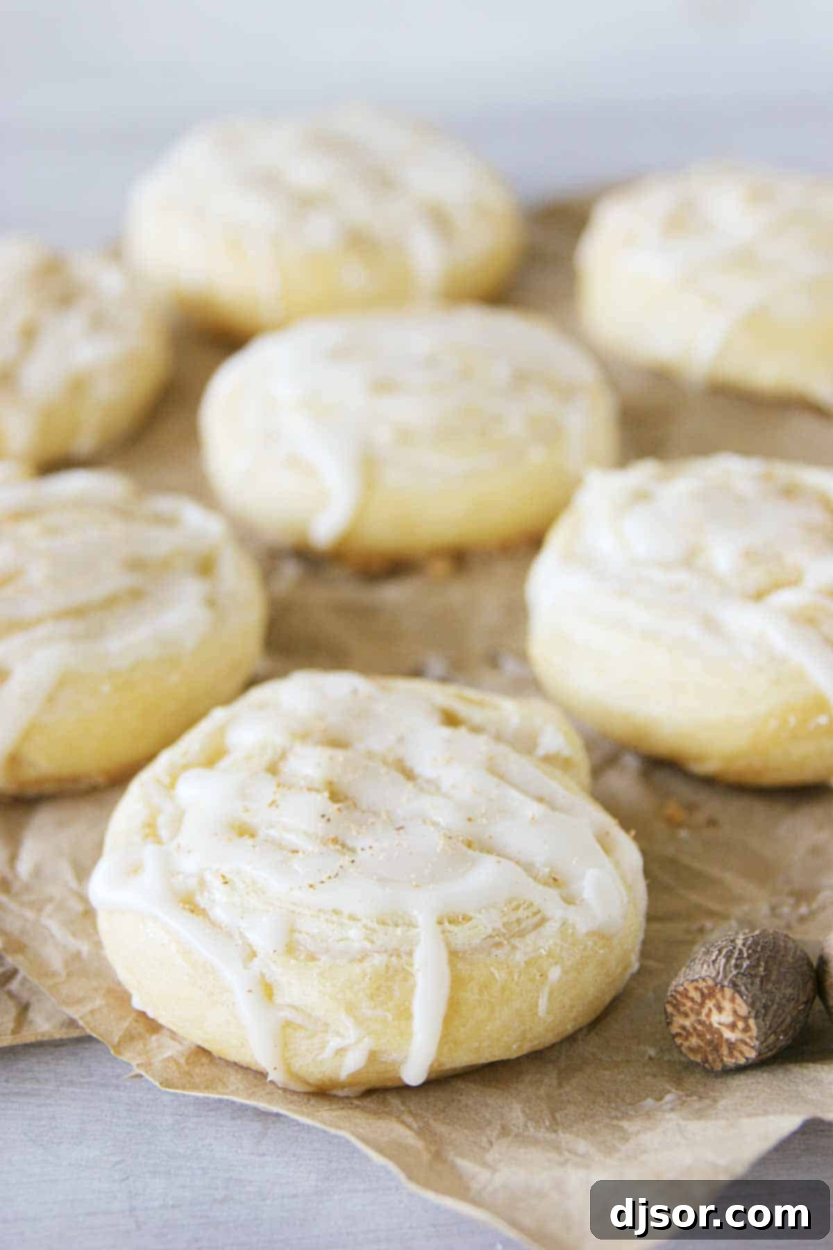 Spiced Eggnog Pinwheel Treats 3 Close-up of Easy Eggnog Pinwheels arranged on brown parchment paper, highlighting their perfect spiral shape and inviting texture