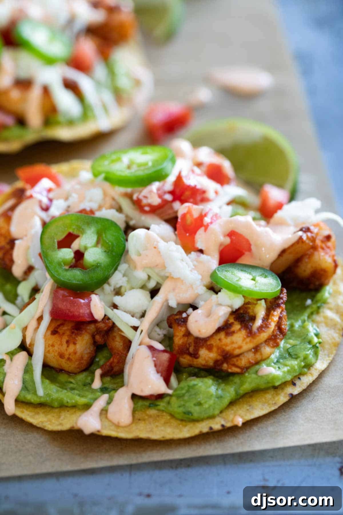 Easy spicy shrimp tostadas with guacamole and a spicy sauce.