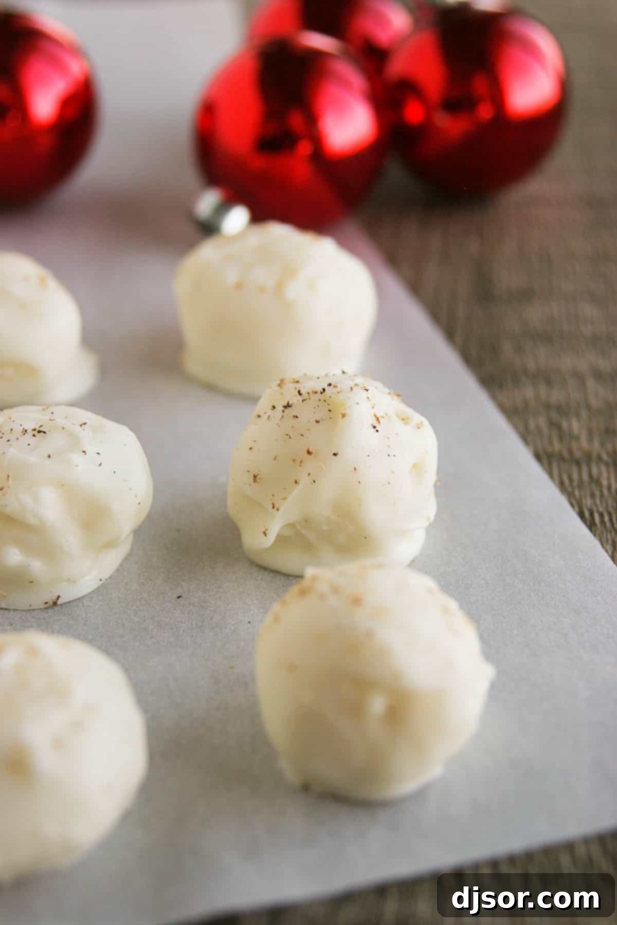 Close-up of freshly made Eggnog Truffles, generously sprinkled with ground nutmeg for added flavor and a festive presentation.