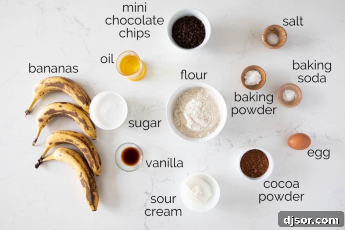 A flat lay photograph showing all the fresh ingredients needed to bake delicious Chocolate Banana Muffins.
