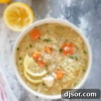 Zesty Lemon Chicken Orzo Soup 2 Bowl of Lemon Chicken Orzo Soup topped with lemon slices and parmesan cheese.