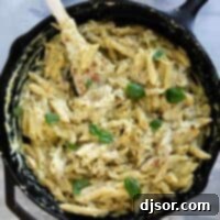 Creamy Pesto Chicken Pasta 8 Cast iron skillet filled with chicken pesto pasta.