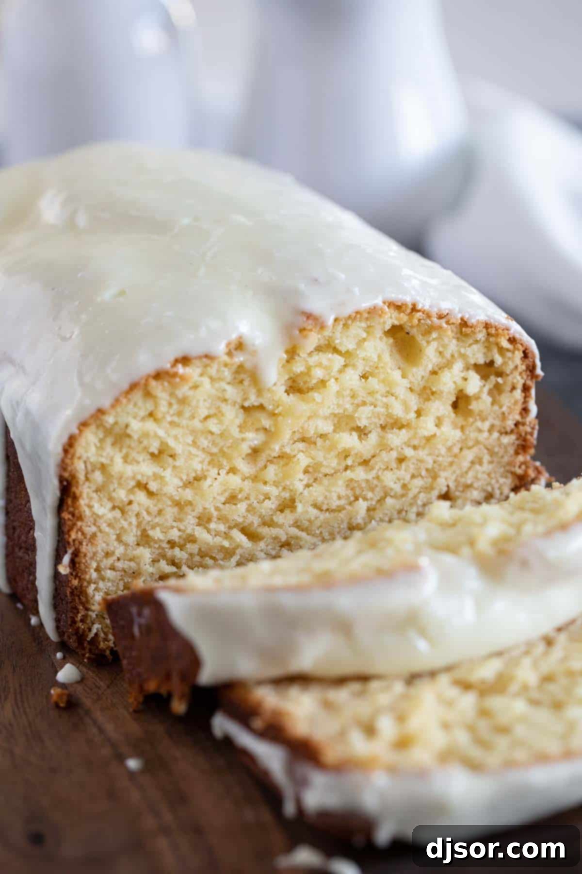 A beautifully baked Eggnog Bread, freshly sliced on a wooden cutting board, showcasing its tender crumb and inviting texture.