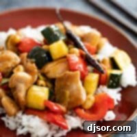 Kung Pao Chicken on a brown plate with rice