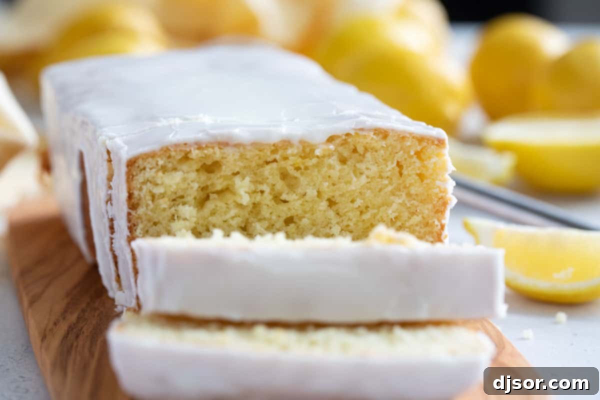 Moist and flavorful homemade Lemon Loaf, better than Starbucks Iced Lemon Loaf with a few slices cut from the loaf.