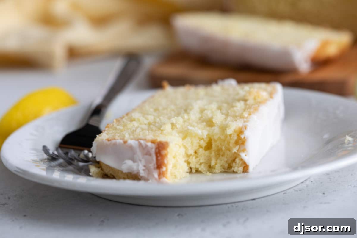 Enjoying a bite of the delicious Lemon Loaf Slice of lemon loaf with a bite taken from it.