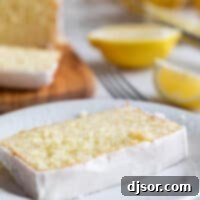 Zesty Lemon Loaf 2 Slice of iced Lemon Loaf on a plate.