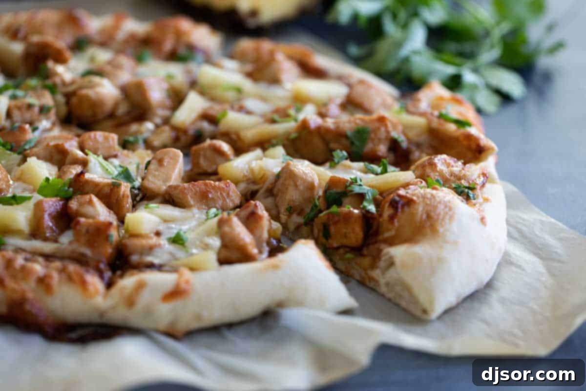 Teriyaki Chicken Pizza with a sweet and savory twist Teriyaki Chicken Pizza cut into slices, showcasing the rich teriyaki sauce, tender chicken, and vibrant pineapple