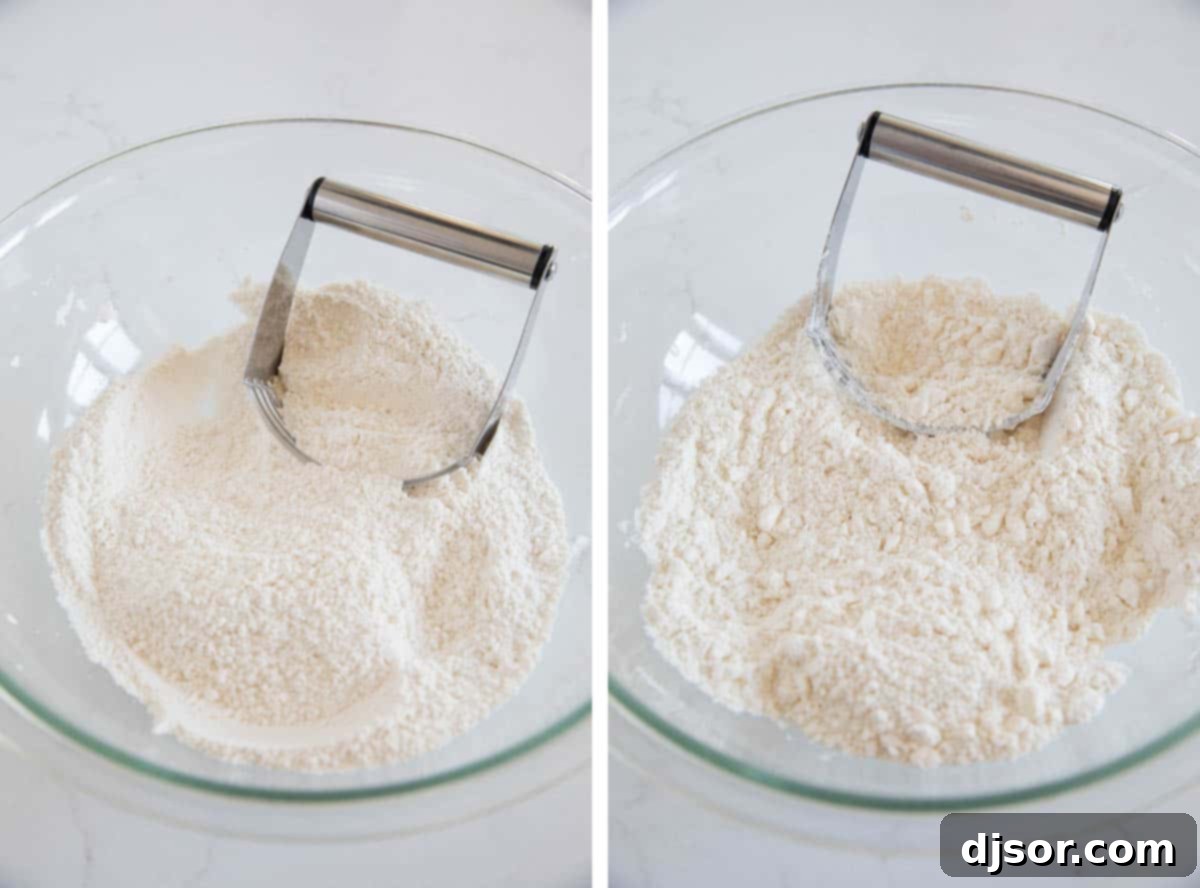 A pastry cutter being used to cut cold butter into dry ingredients in a bowl for scone dough.