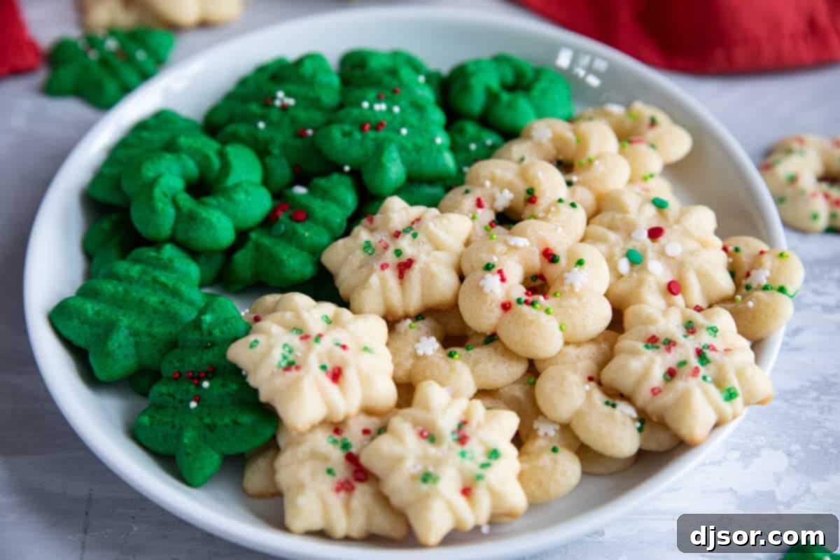 Homemade Spritz Cookies A Step-by-Step Guide 2 Wreath, snowflake, and Christmas tree spritz cookies with holiday sprinkles.