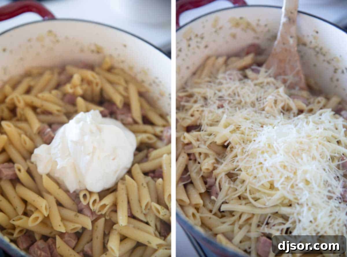 Finishing Creamy Ham and Cheese Pasta with Ranch Stirring sour cream and cheese into cooked pasta and ham in a Dutch oven