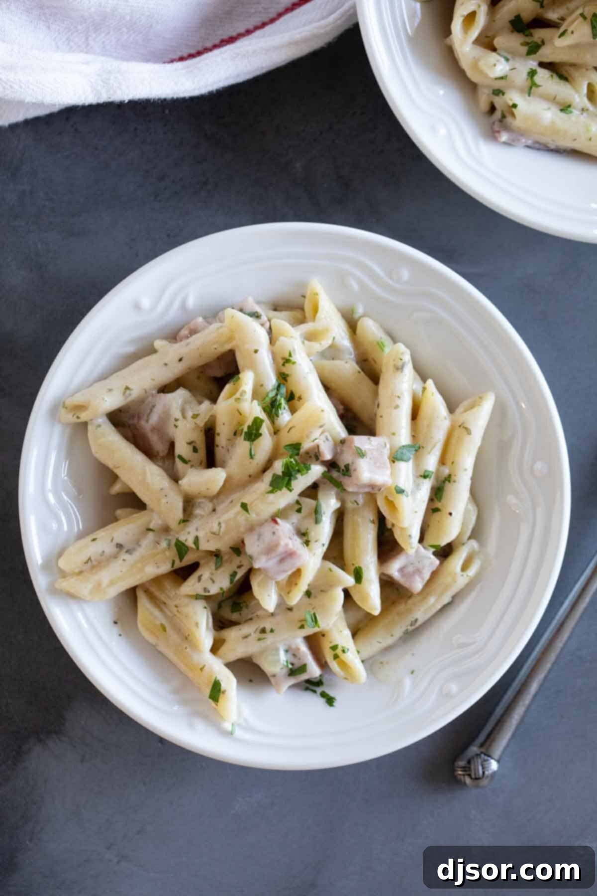 Hearty Penne Pasta with Ham and Creamy Ranch Cheese Sauce Close-up of penne pasta with ham and rich, cheesy sauce, ready to serve
