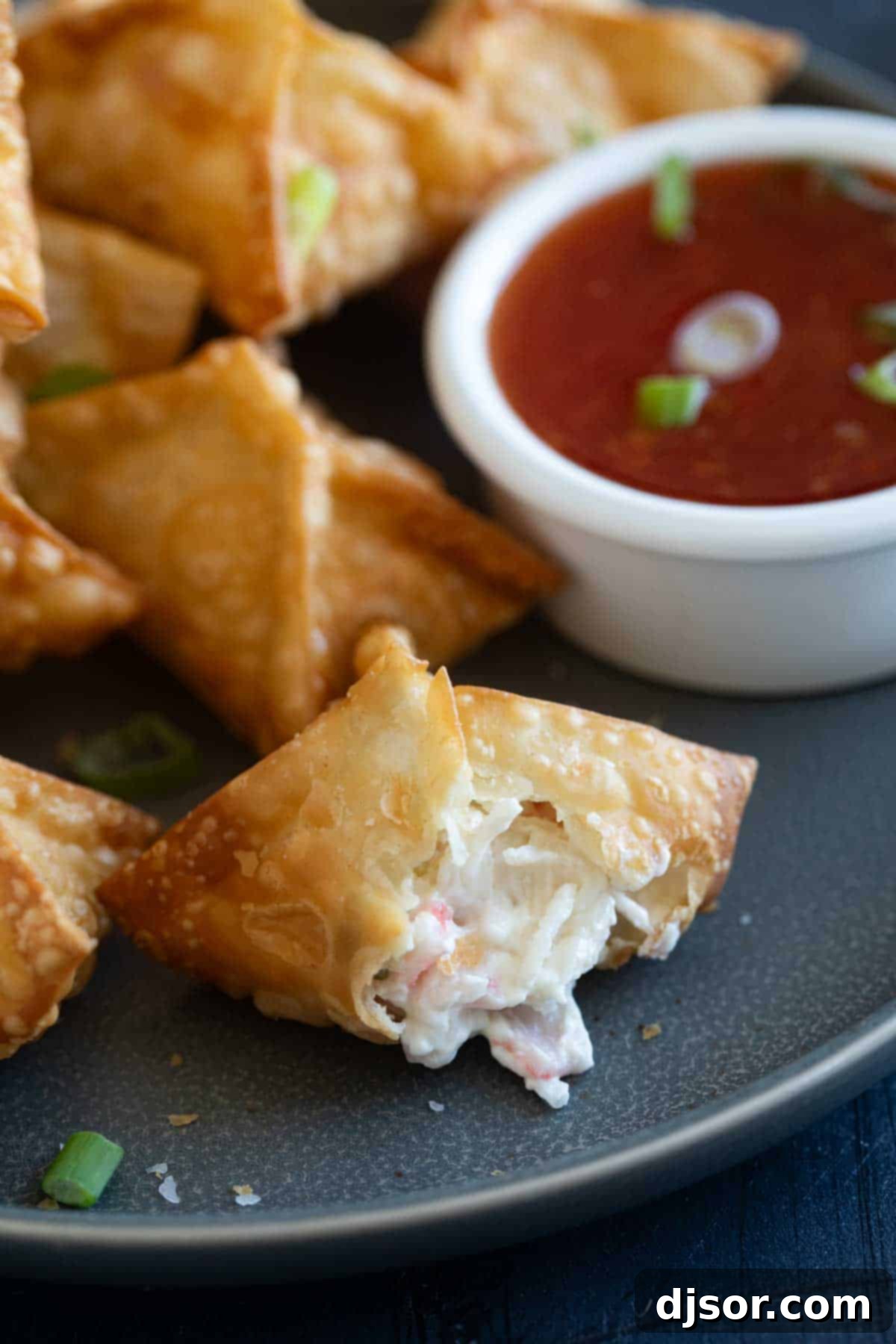 Crab Rangoon with a bite taken from one.