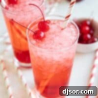 Glasses of Shirley Temples, garnished with maraschino cherries, ready to be served.