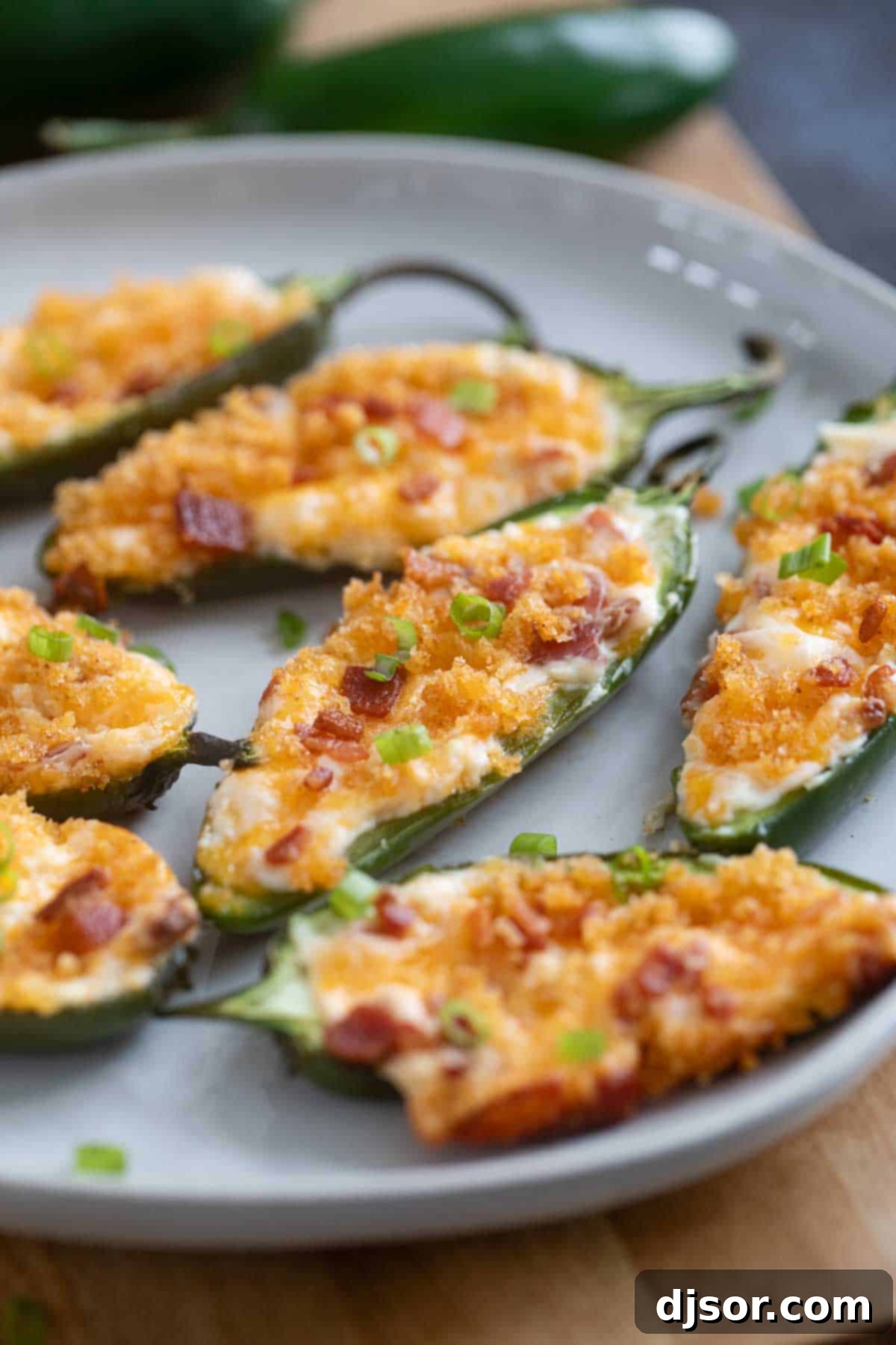 Jalapeño Poppers topped with breadcrumbs and bacon.