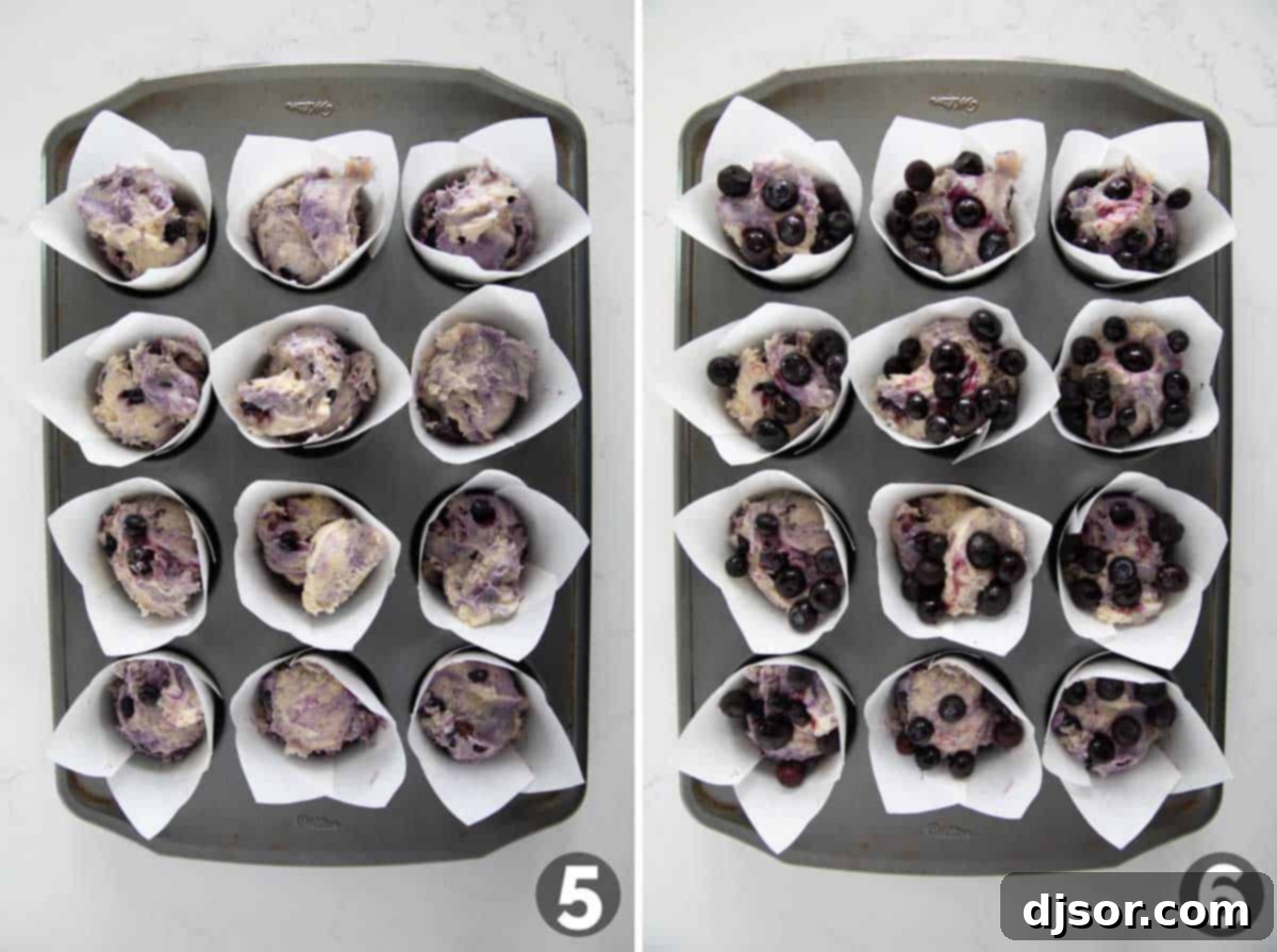 Muffin cups being filled with blueberry muffin batter.