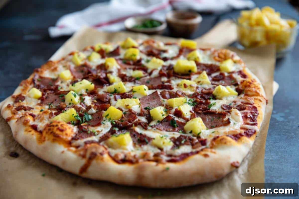 A vibrant, fully baked Hawaiian Pizza, richly topped with glistening pineapple chunks, crispy bacon pieces, savory ham, and bubbling melted cheese, resting on a sheet of parchment paper.