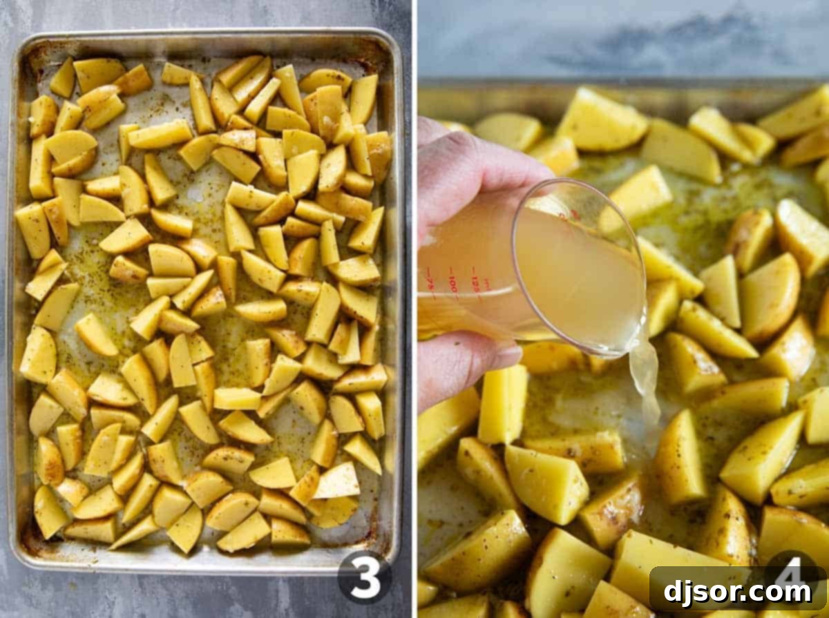A baking sheet filled with perfectly arranged, single-layer Greek Lemon Potatoes, with broth being carefully poured around them.