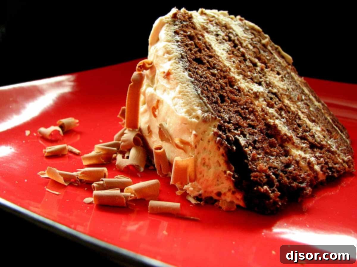 A stunning multi-layered Chocolate Torte with fluffy cream cheese frosting, elegantly adorned with chocolate curls, inviting dessert lovers to indulge in its rich flavor.