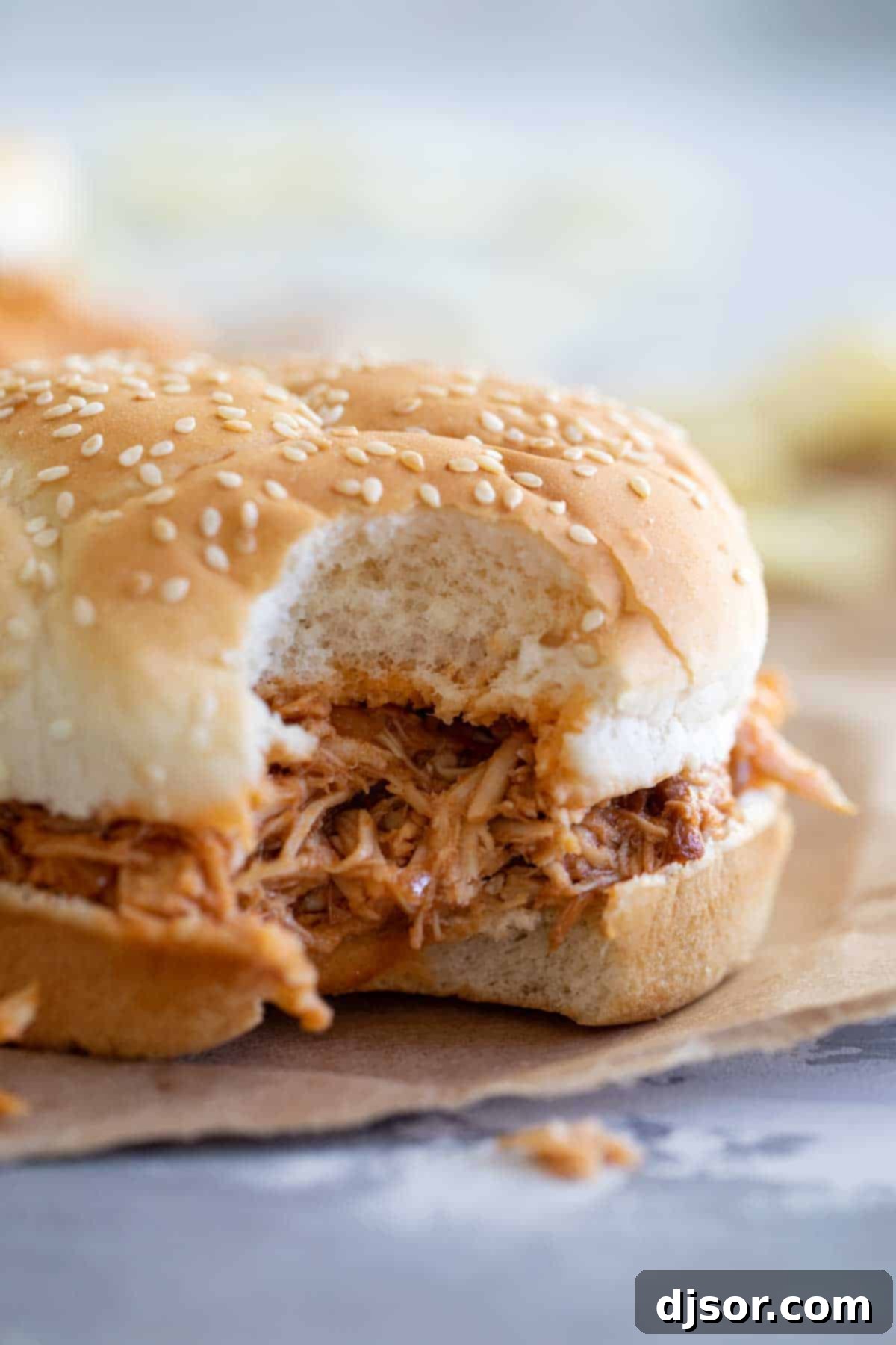 Crockpot BBQ Pulled Chicken Sandwich, a satisfying meal A delicious Crockpot BBQ Pulled Chicken Sandwich with a bite taken out.