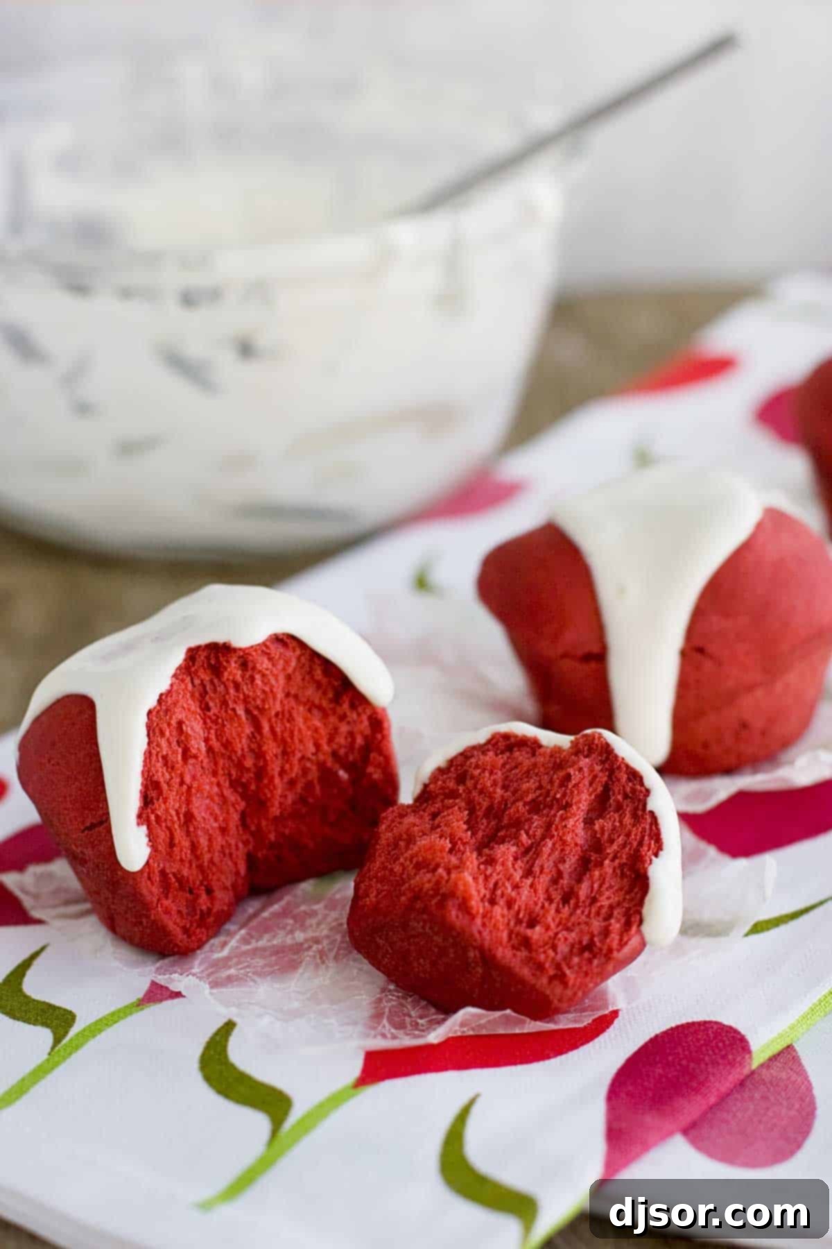 A perfectly torn Red Velvet Roll, revealing its soft, fluffy texture and vibrant red color.