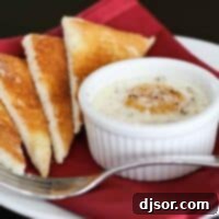 Creamy Spinach and Baked Eggs 2 Close-up of baked egg with creamed spinach in a ramekin, served with toast triangles.