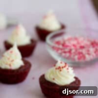 Decadent Red Velvet Brownie Bites 2 Red velvet brownie cups filled with cream cheese and topped with sprinkles.