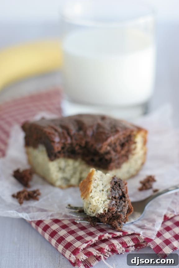 Moist and Flavorful Black and White Banana Cake Slice Close-up of a slice of Black and White Banana Cake, showing its moist texture and beautiful contrast