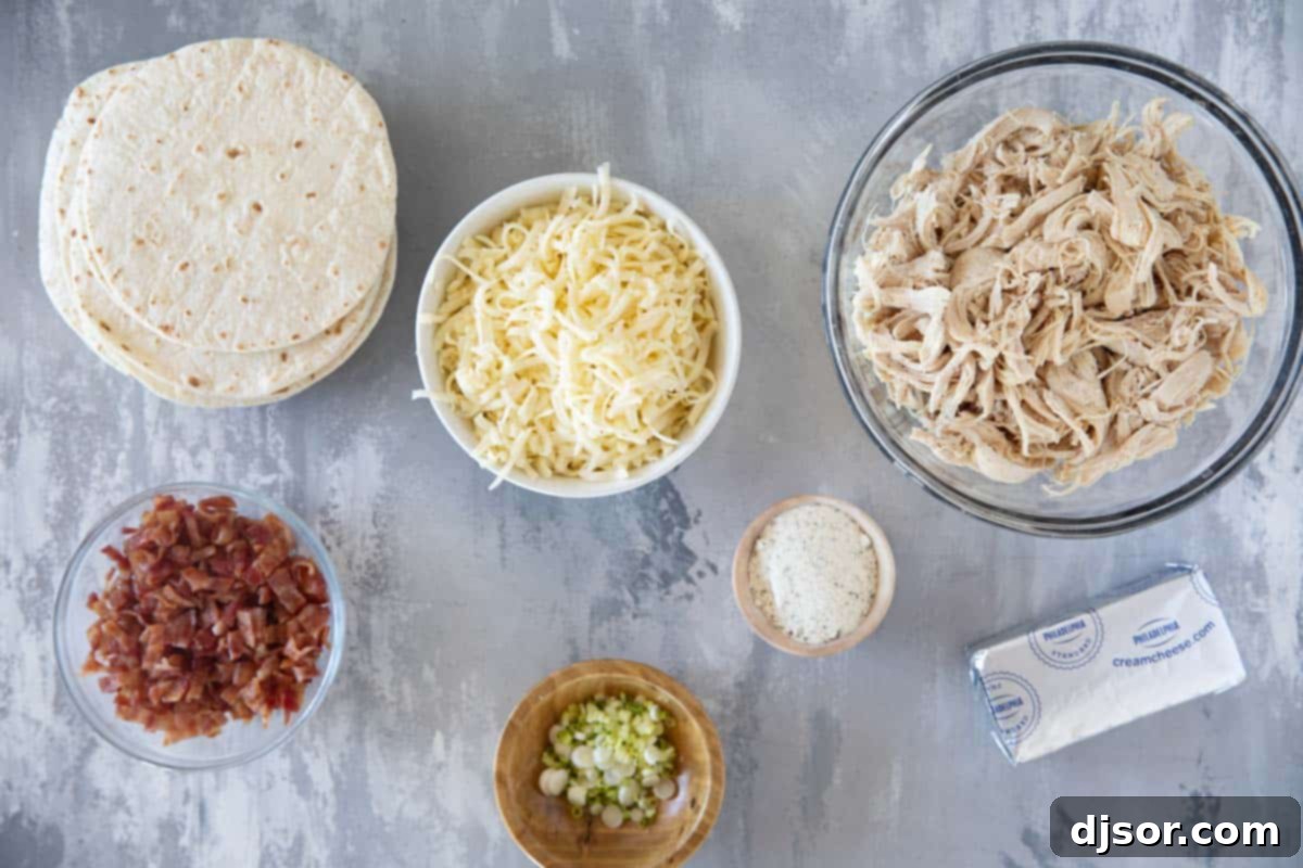 A bowl filled with the ingredients for Baked Chicken Bacon Ranch Taquitos, including shredded chicken, cooked bacon crumbles, cheese, and green onions.