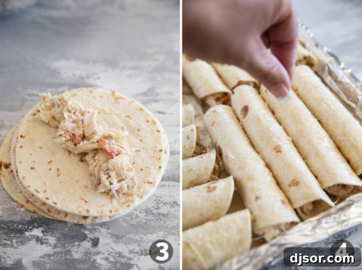 A hand placing chicken bacon ranch filling into a flour tortilla, rolling it up, and sprinkling coarse salt on top of rolled taquitos on a baking sheet.