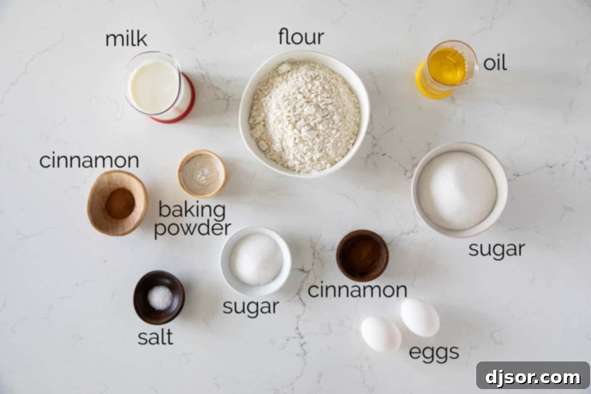 Close-up shot of individual ingredients for Cinnamon Muffins laid out on a kitchen counter, including flour, sugar, cinnamon, eggs, milk, and oil.