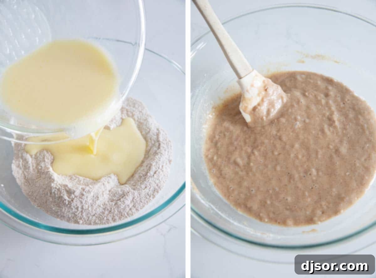 A large bowl containing dry ingredients with a well in the center, and wet ingredients being poured into it, showing the mixing process for muffin batter.