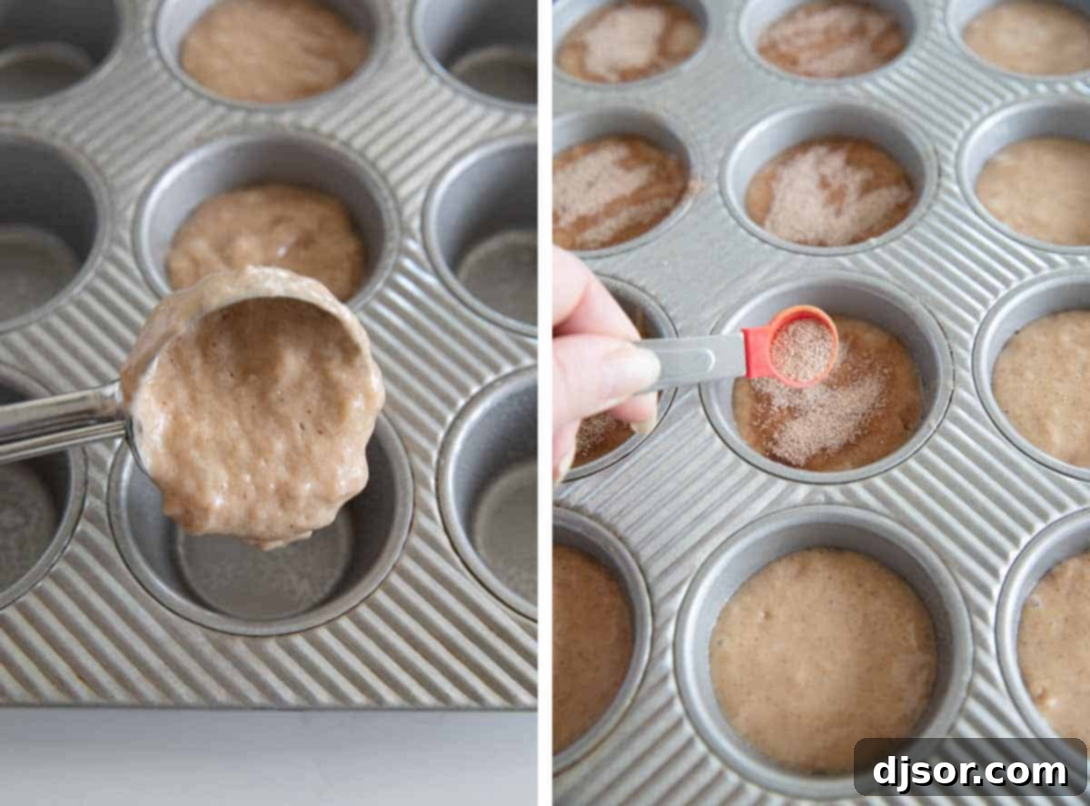 Muffin tin filled with batter, topped with a sprinkle of cinnamon sugar, ready for baking.