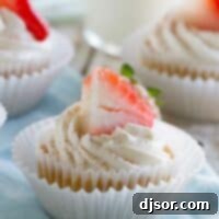 Tres Leches Cupcakes topped with a strawberry