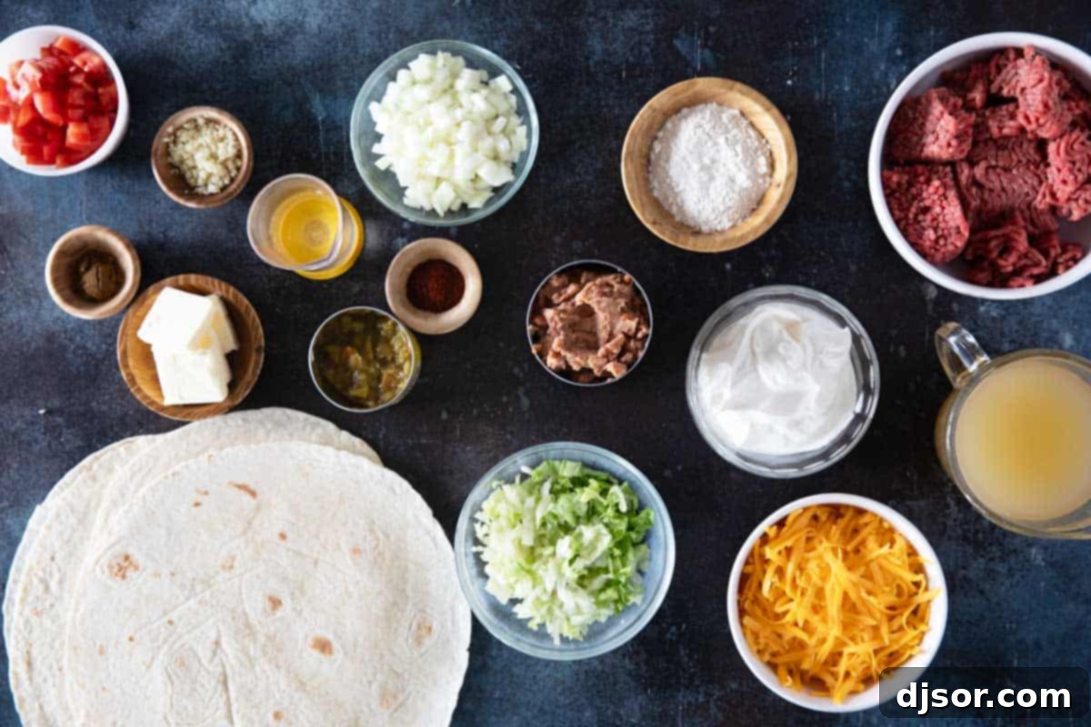 All the fresh ingredients laid out on a white surface for making Smothered Burritos with Green Chile Sauce.