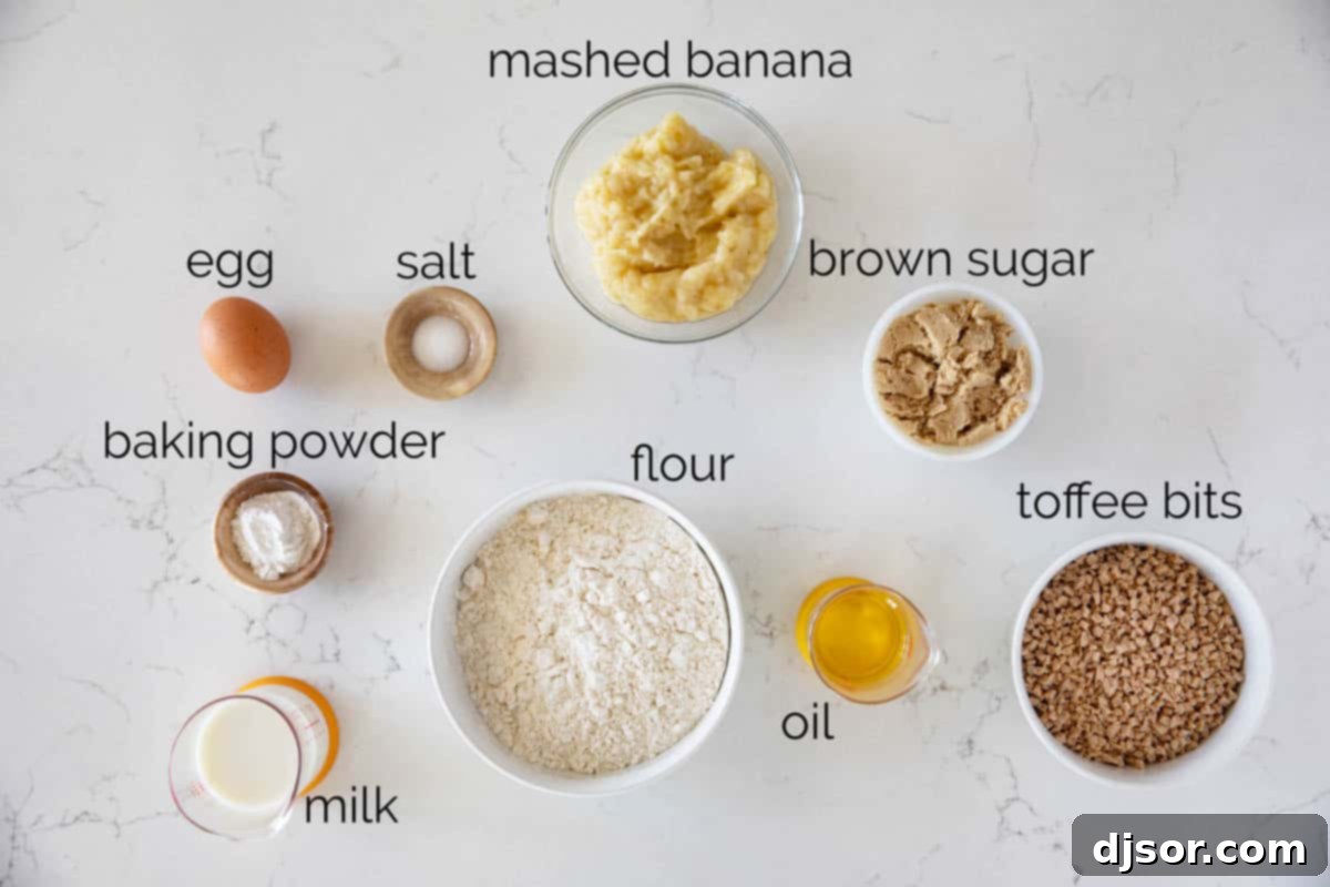 Banana Toffee Treat Muffins 3 Array of essential ingredients laid out to prepare Banana Toffee Muffins, including flour, sugar, bananas, milk, oil, and toffee bits.