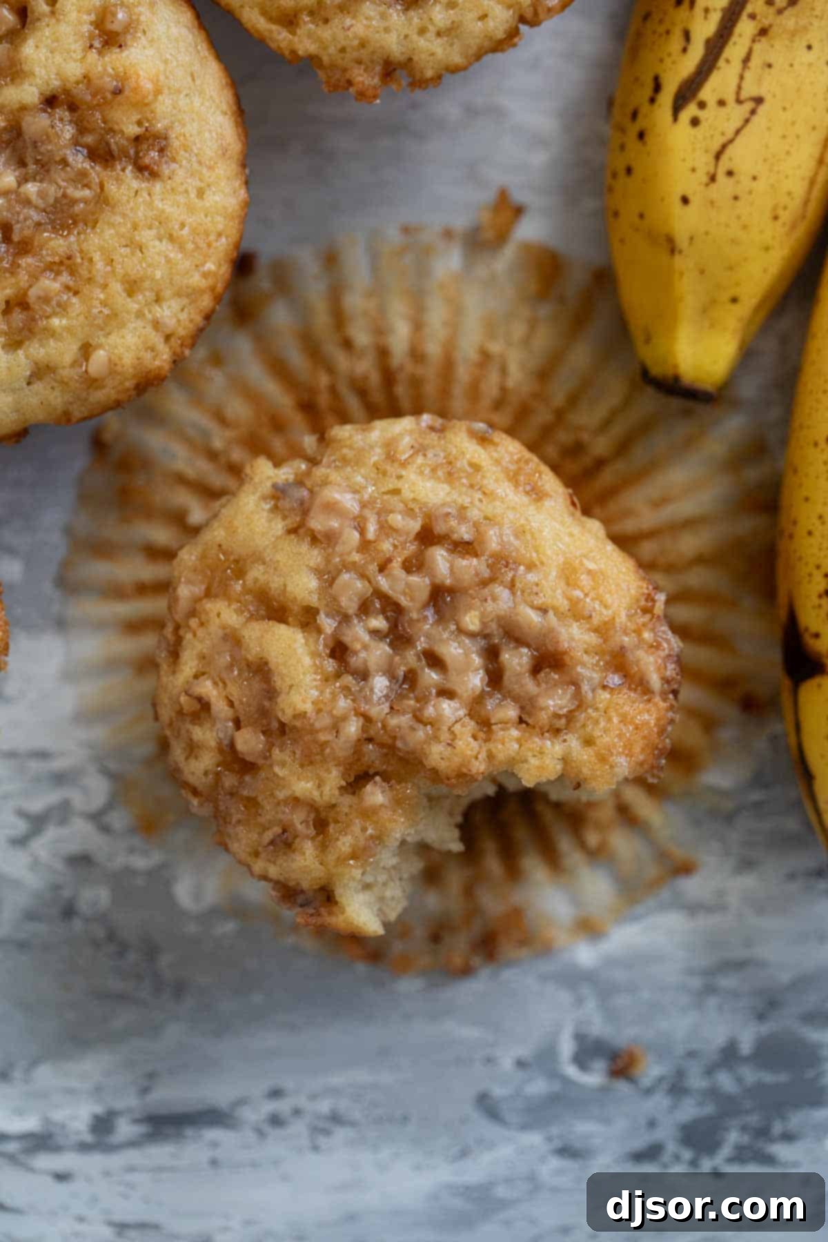 Banana Toffee Treat Muffins 9 A single Banana Toffee Muffin presented beautifully, showcasing its golden hue and generous toffee topping.