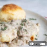 Plate of homemade biscuits and sausage gravy, a comforting classic.